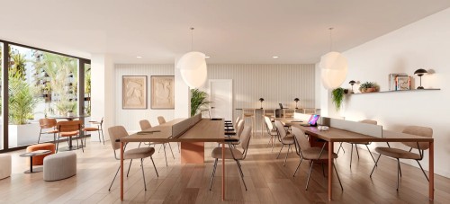 Espacio de coworking comunitario en Insur Elyonia, diseñado para el teletrabajo con mesas tecnológicas, iluminación LED y grandes ventanales que permiten el aprovechamiento máximo de la luz natural.